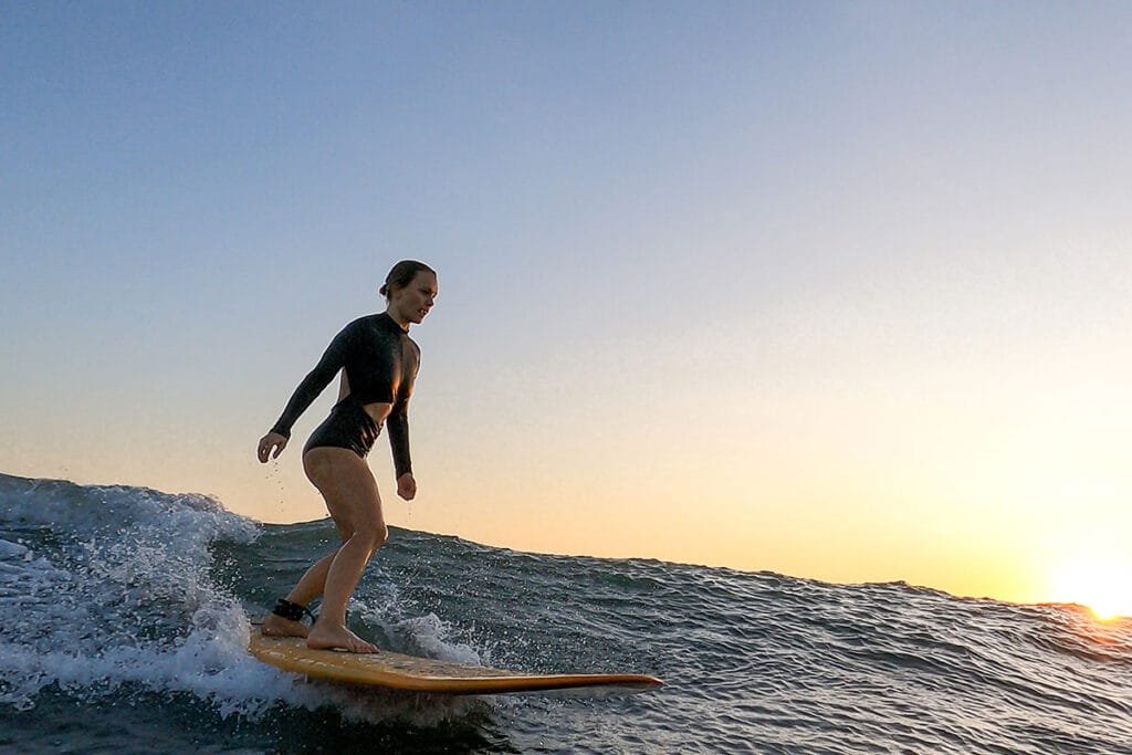 Surf lessons in the beach sunset session in Kuta Bali Best choice for you and friend, partner or family for your first surf experience.